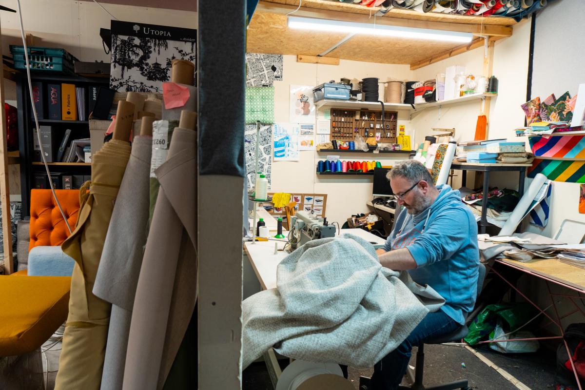 Upholstering in a studio setting with sewing machine